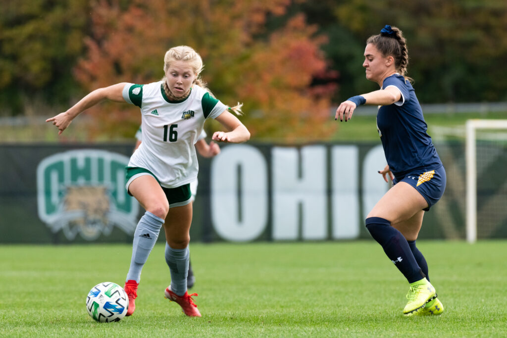 Abby Townsend, number 16 of the Ohio Bobcats, beats Kent defender Lauryn Arruda during their game against the Kent State Flashes on Thursday, Oct. 28, 2021 at Chessa Feild. The Bobcats tied the Flashes 0-0.