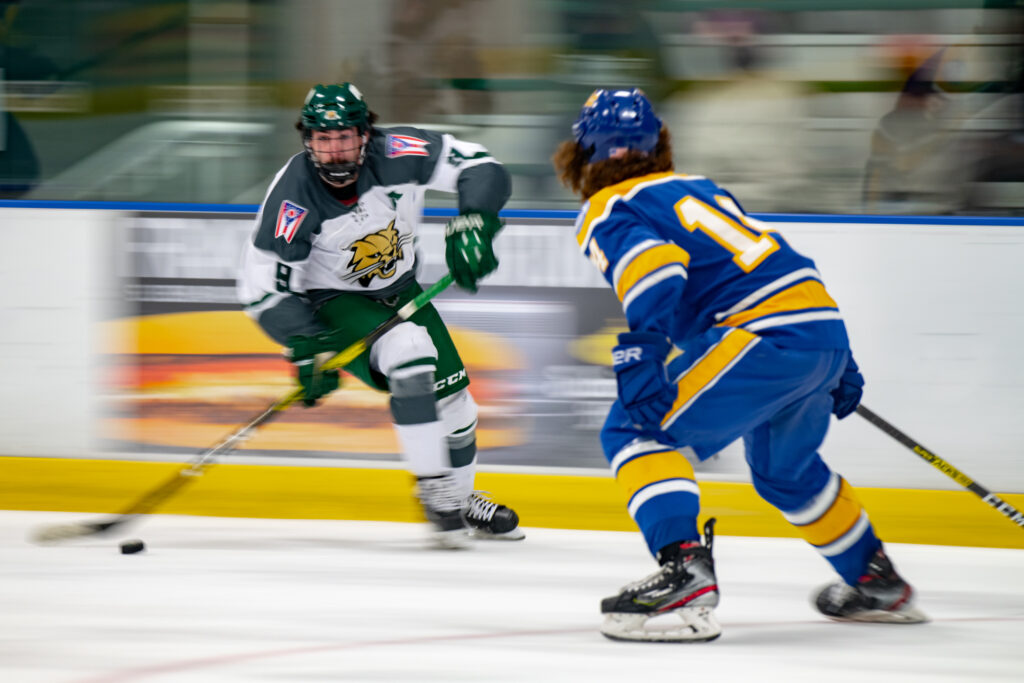 Ryan Higgins (9), a forward for the Ohio University Hockey Team, carries the puck down the rink towards the Panthers goal in their game against the University of Pittsburgh at Bird Arena on Oct. 2, 2021. The Panthers went to win the game 5-2. [Alex Eicher]