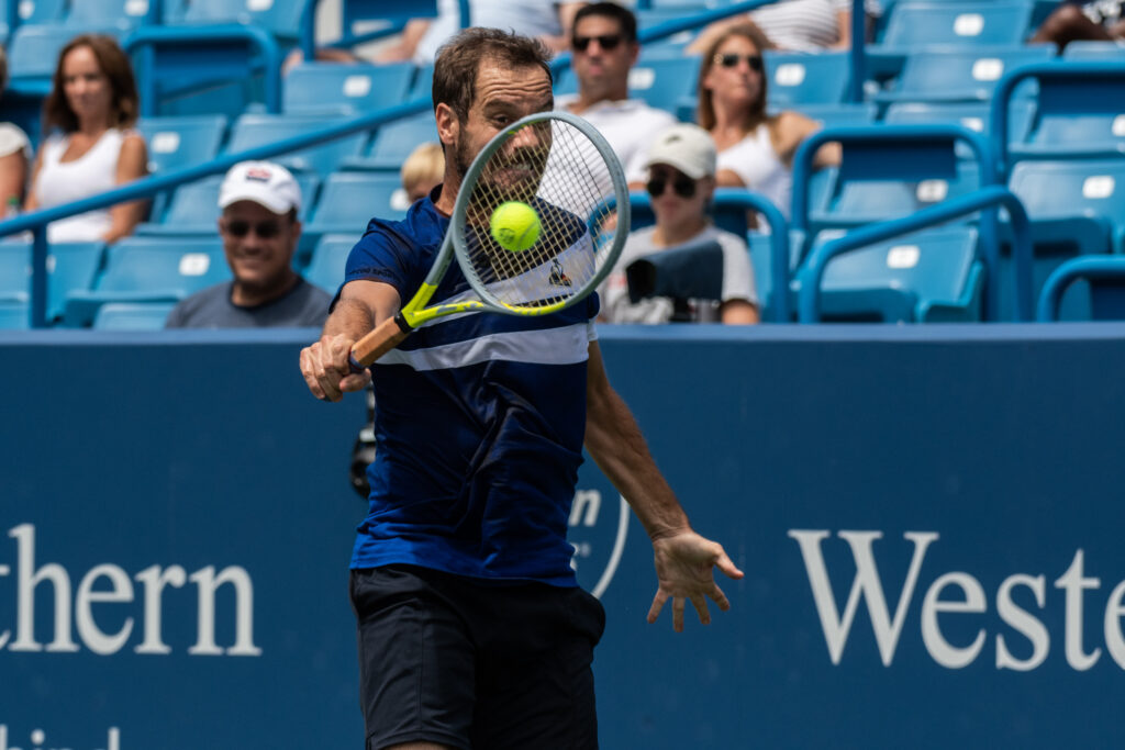 Richard Gasquet backhands the ball back toward Fernando Verdasco during their match at the Western and Southern Open on Saturday, Aug. 14, 2021. Gasquet won the set 2-0